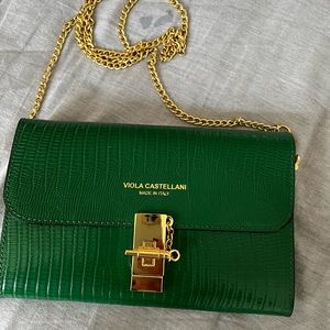 Is Green Clutch with a golden chain.